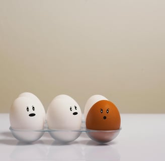 three eggshells with faces drawn on them