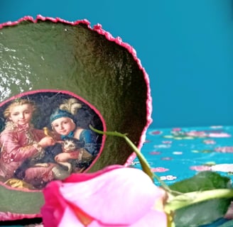 a decorative bowl with 18th century collage, vibrant colors