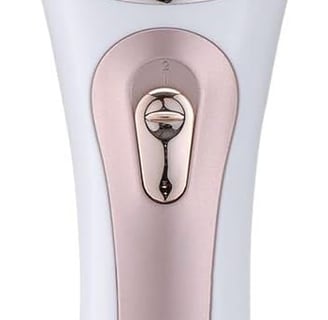 a close up of a pink and white electric shaver