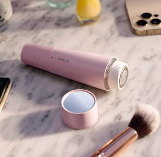 a pink portable speaker with a pink and white background