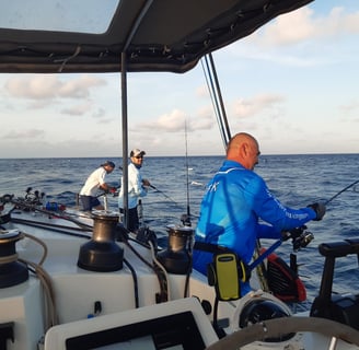 Anglers jigging on a catamaran - Catamaran Fishing Charters Seychelles