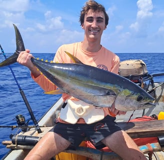 Happy client with a yellowfin tuna on a Zanzibar Catamaran Fishing Charter