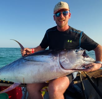  client with a tuna on a Zanzibar Catamaran Fishing Charter