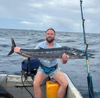Angler holding a Wahoo in Zanzibar waters