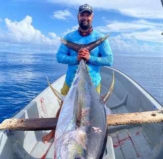 Angler proudly displaying a Yellowfin Tuna caught on a Full-Day Fishing Charter in Zanzibar