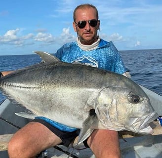 Angler holding a Giant Trevally after a successful Half-Day Fishing Charter in Zanzibar