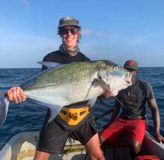 Angler showcasing a Bluefin Trevally on a Full-Day Fishing Charter in Zanzibar