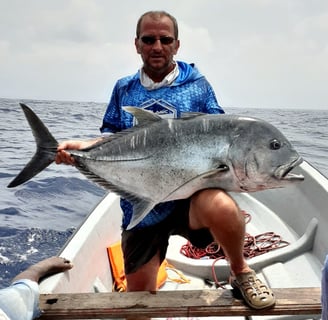 Angler holding a giant trevally on a Catamaran Fishing Charter in Zanzibar