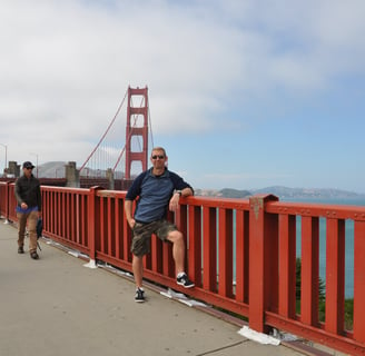 a man standing on the golden gate bridge over looking at the golden gate bridge