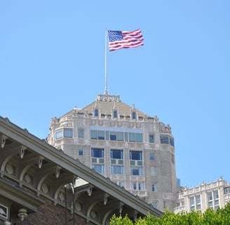 a flag flying over a building with a flag on topin san francisco