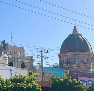 a church with a dome shaped building in the background