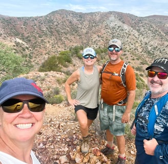 a group of people standing on a mountain top