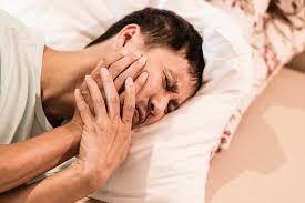 Person sleeping with tooth pain at night