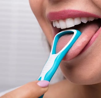 a girl using tongue cleaner in mouth