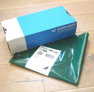 a  foot impression box with returns envelope