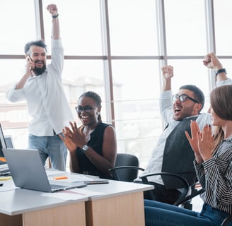 a group of people celebrating new Deals with rainmakers sales coaching
