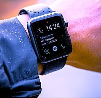 a person wearing a black watch and a black watch