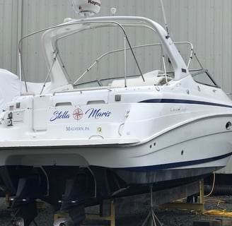 a boat sitting on a trailer with a boat in the background