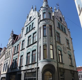 a building with a clock tower in the middle of a city