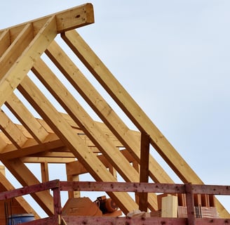 Roof trusses made out of wood during the building phase with wooden scaffolding attached