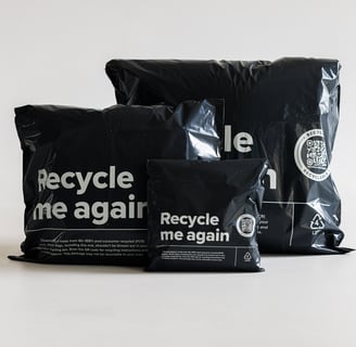 three black recyclable mailers in different sizes