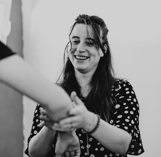 a woman holding a man's hand and smiling