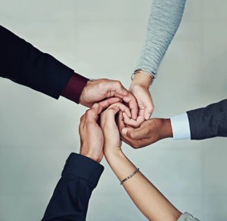 a group of people holding hands together