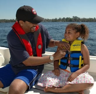 a man and a little girl in life jackets