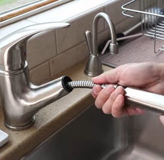 Removing the nut from the faucet for replacement