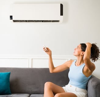 a woman sitting on a couch with a remote control