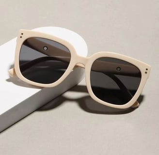 a pair of sunglasses with a white box and a white box