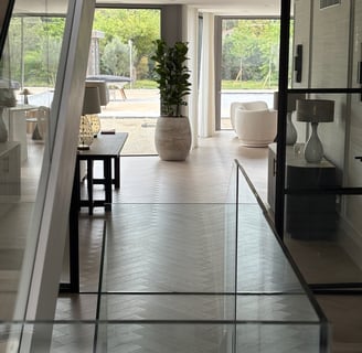 A light oak herringbone floor running throughout an open plan house