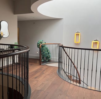 A brown oak plank floor in a curved hallway