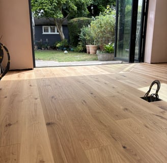 An oak plank floor in a kitchen extension with bifolding doors
