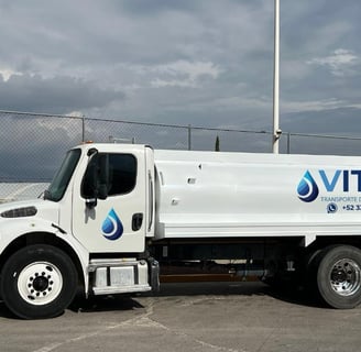 a white truck with a large water tank on it
