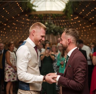 Two men hold hands on their wedding day