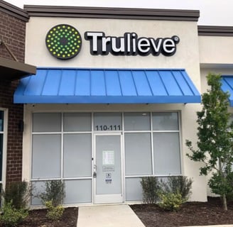 Trulieve storefront with a blue awning in Palm Coast, Florida.