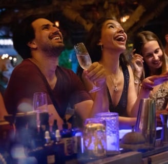a group of people sitting at a bar