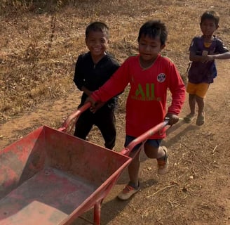 boys-pushing-wheelbarrow