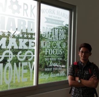 a man standing in front of a window with a window