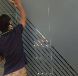 a man standing in a room with a glass door