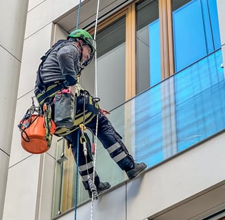 a man in a helmet is climbing up a building