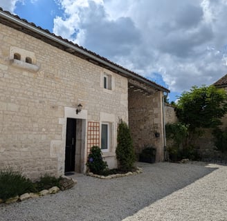 a stone building with a door and a door way to the outside