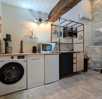 a kitchen with a washing machine and a washing machine