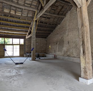 a room with a large wooden ceiling and a wooden floor