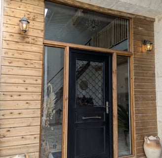 a black door with a black door and a potted planter