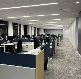 A large room filled with office cubicles.