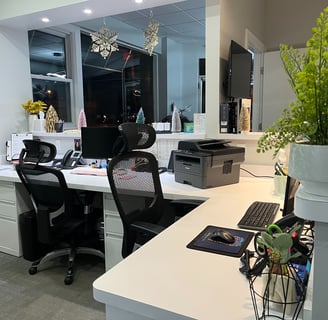 The desks inside a dental office's receptionist area.