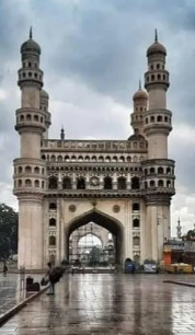 A ancient structure with cement color and windows