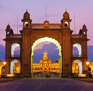 A palace entrance illuminated with lights during the night time